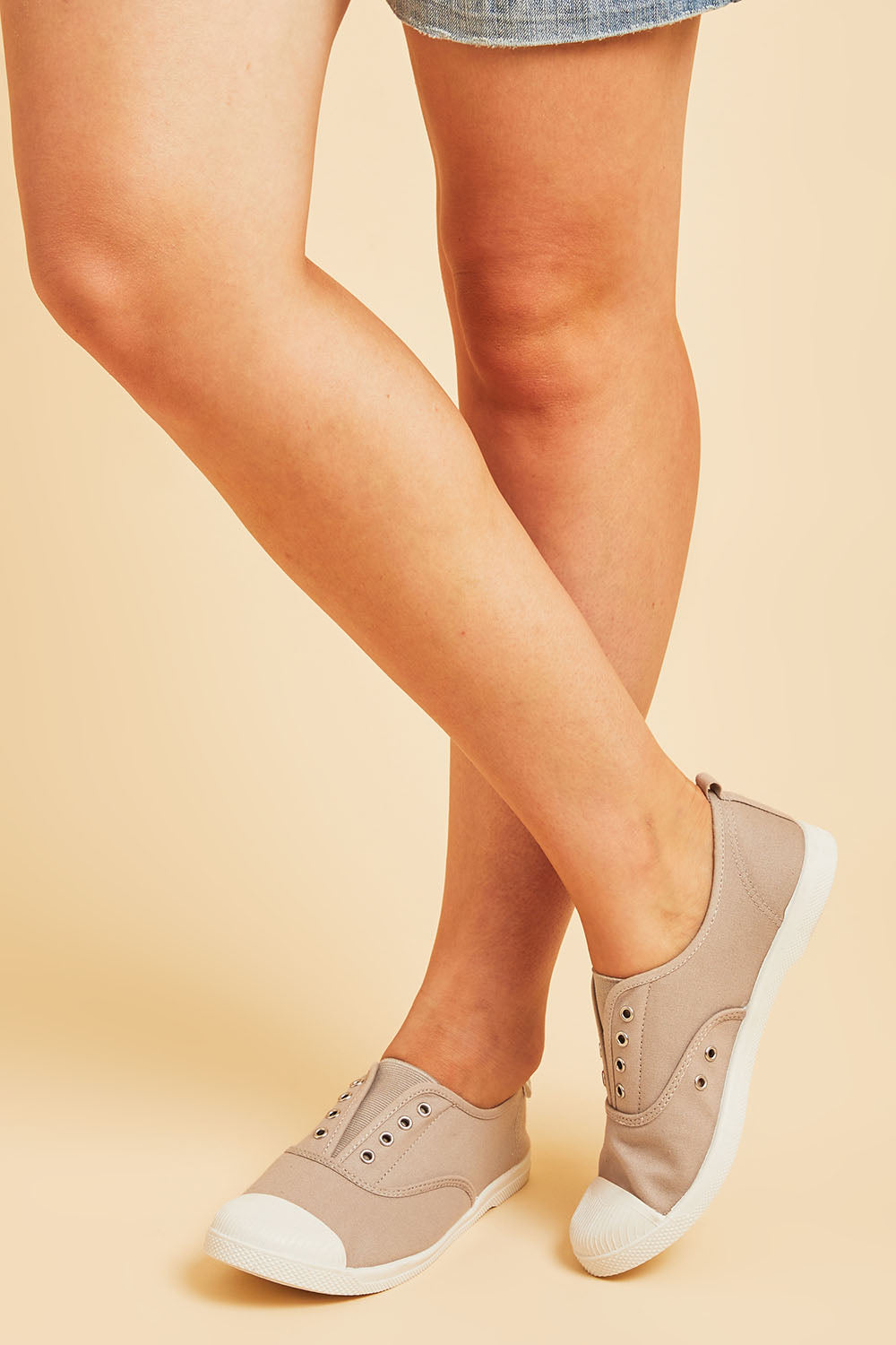 A model wearing size 38 of the Euro Elastic Plimsole in colour Grey (Grey), from the front, cropped image