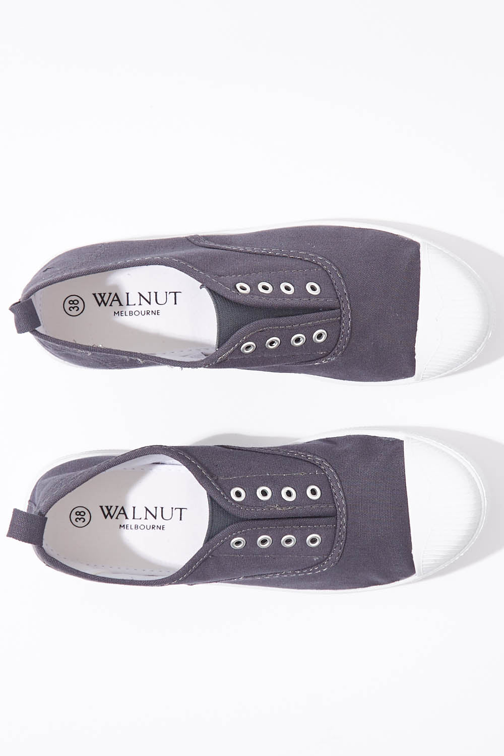 A model wearing size 37 of the Euro Elastic Plimsole in colour Midnight (Blue), from the front, showing the whole outfit