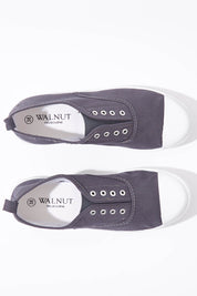 A model wearing size 37 of the Euro Elastic Plimsole in colour Midnight (Blue), from the front, showing the whole outfit