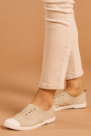 A model wearing size 39 of the Euro Elastic Plimsole in colour Sand, from the front, cropped image