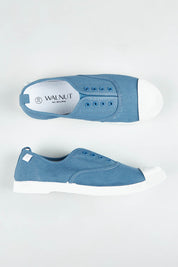 A model wearing size 37 of the Euro Plimsole in colour Denim (Blue), from the front, showing the whole outfit