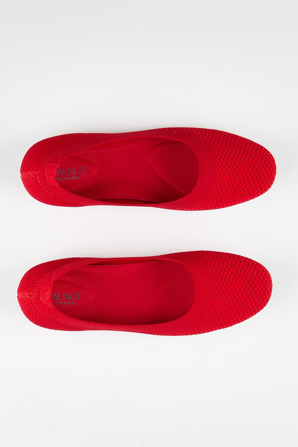 Model Genericm wearing size sample of the Eva Knit Ballet Flat - Red in colour Red, in a cropped view