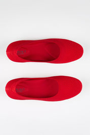 Model Genericm wearing size sample of the Eva Knit Ballet Flat - Red in colour Red, in a cropped view