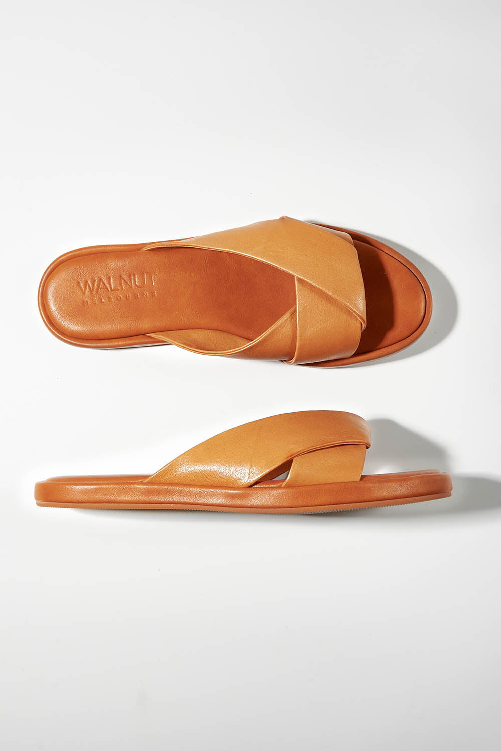 A model wearing size 37 of the Lauren Leather Slide in colour Coconuttan, from the front, showing the whole outfit