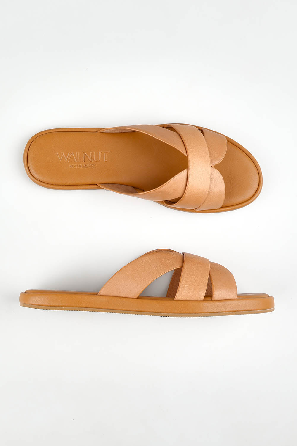 A model wearing size 37 of the Lola Leather Slide in colour Cocotan (White), from the front, showing the whole outfit