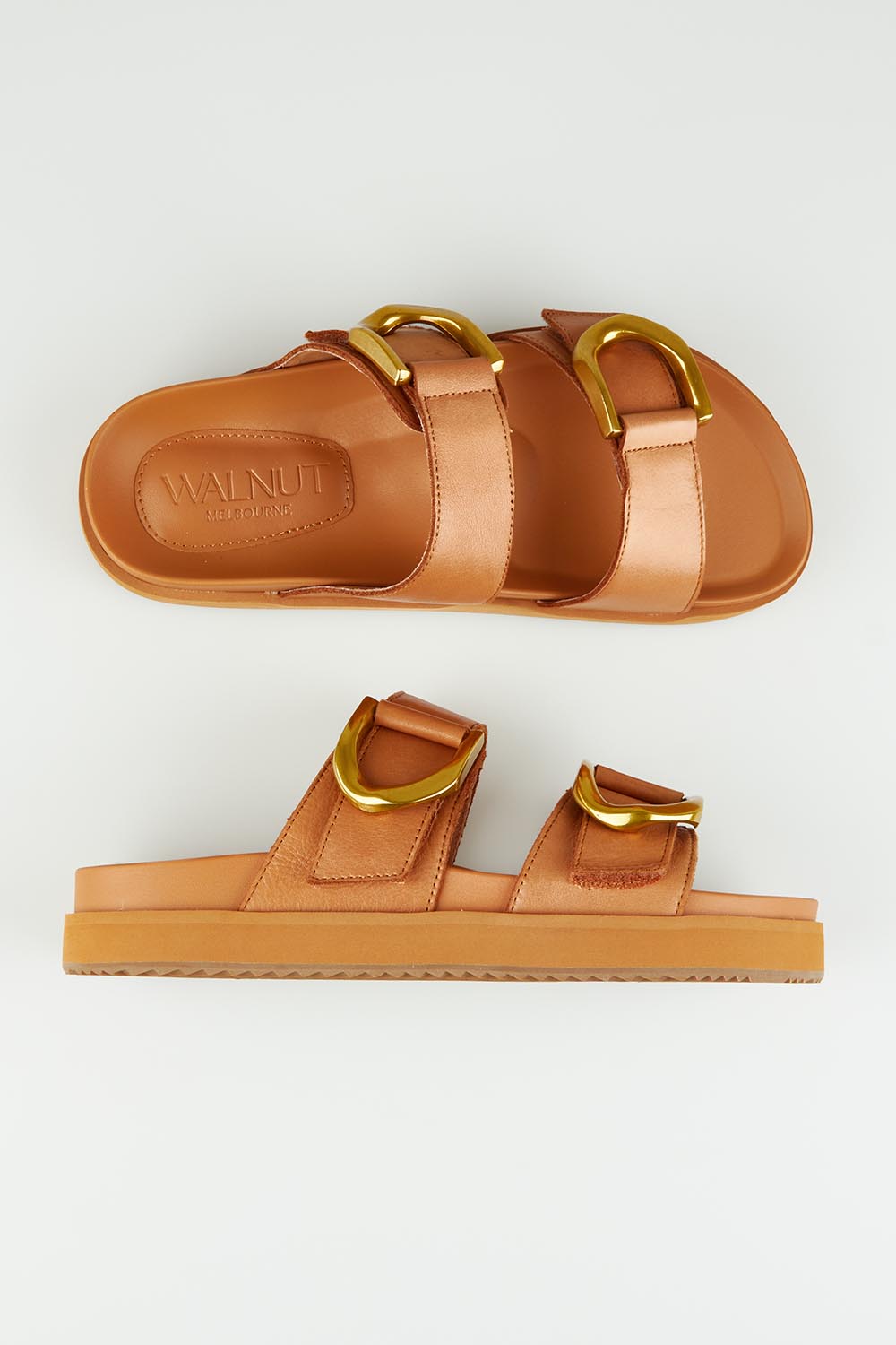 A model wearing size 37 of the Mint Leather Slide in colour Coconut, from the front, showing the whole outfit