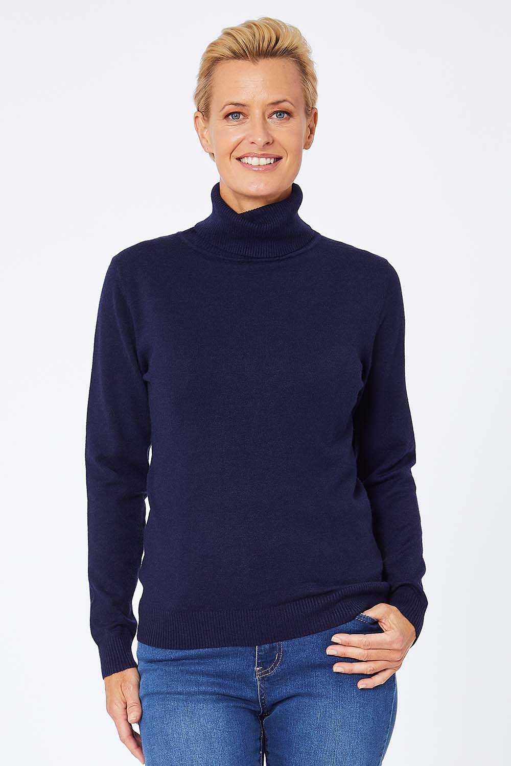 Model Amelia wearing size S of the Turtle Neck Jumper in colour Navy (Blue), from the front, cropped image