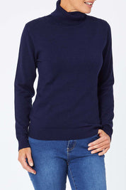 Model Amelia wearing size S of the Turtle Neck Jumper in colour Navy (Blue), from the front, cropped image
