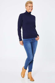 Model Amelia wearing size S of the Turtle Neck Jumper in colour Navy (Blue), from the front, showing the whole outfit