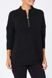 Model Amelia wearing the 3/4 Sleeve Zip Neck Jumper in colour Black (Black), from the front, cropped image