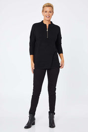Model Amelia wearing the 3/4 Sleeve Zip Neck Jumper in colour Black (Black), from the front, showing the whole outfit