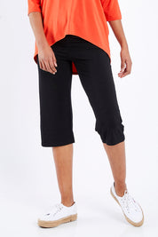 Model Schanez wearing size S of the 3/4 Bamboo Pants in colour Black (Black), from the front, cropped image