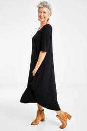 Model Elise wearing size S of the Half Sleeve Bamboo Maxi Dress in colour Black (Black), from the front, showing the whole outfit