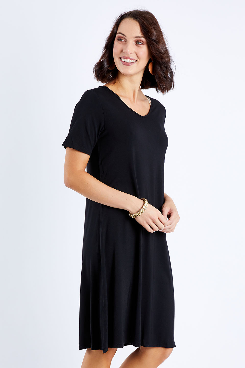 Model Andrea wearing size S of the Short Sleeve Vin colourNeck Bamboo Dress - Black (Black), from the front, cropped image