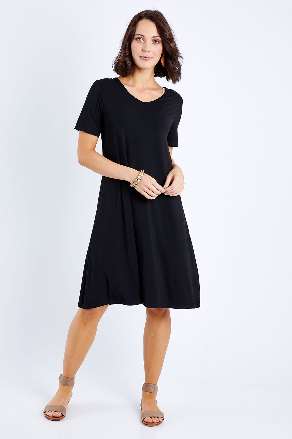Model Andrea wearing size S of the Short Sleeve Vin colourNeck Bamboo Dress - Black (Black), from the front, showing the whole outfit