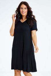 Model Laura wearing size L of the Short Sleeve Vin colourNeck Bamboo Dress - Black (Black), from the front, cropped image