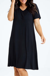 Model Laura wearing size L of the Short Sleeve Vin colourNeck Bamboo Dress - Black (Black), from the front, cropped image
