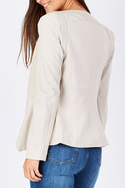 Model Anna wearing the Persuit Jacket in colour Cream, from the front, cropped image