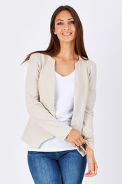 Model Anna wearing the Persuit Jacket in colour Cream, from the front, cropped image