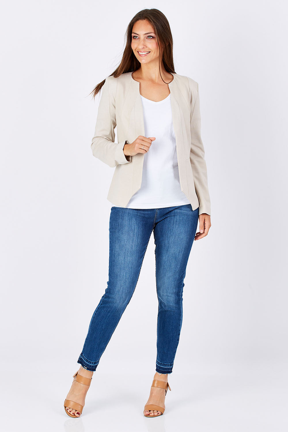 Model Anna wearing the Persuit Jacket in colour Cream, from the front, showing the whole outfit