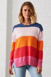 A model wearing the Mega Stripe Pullover in colour Bubblegum (Pink), from the front, showing the whole outfit