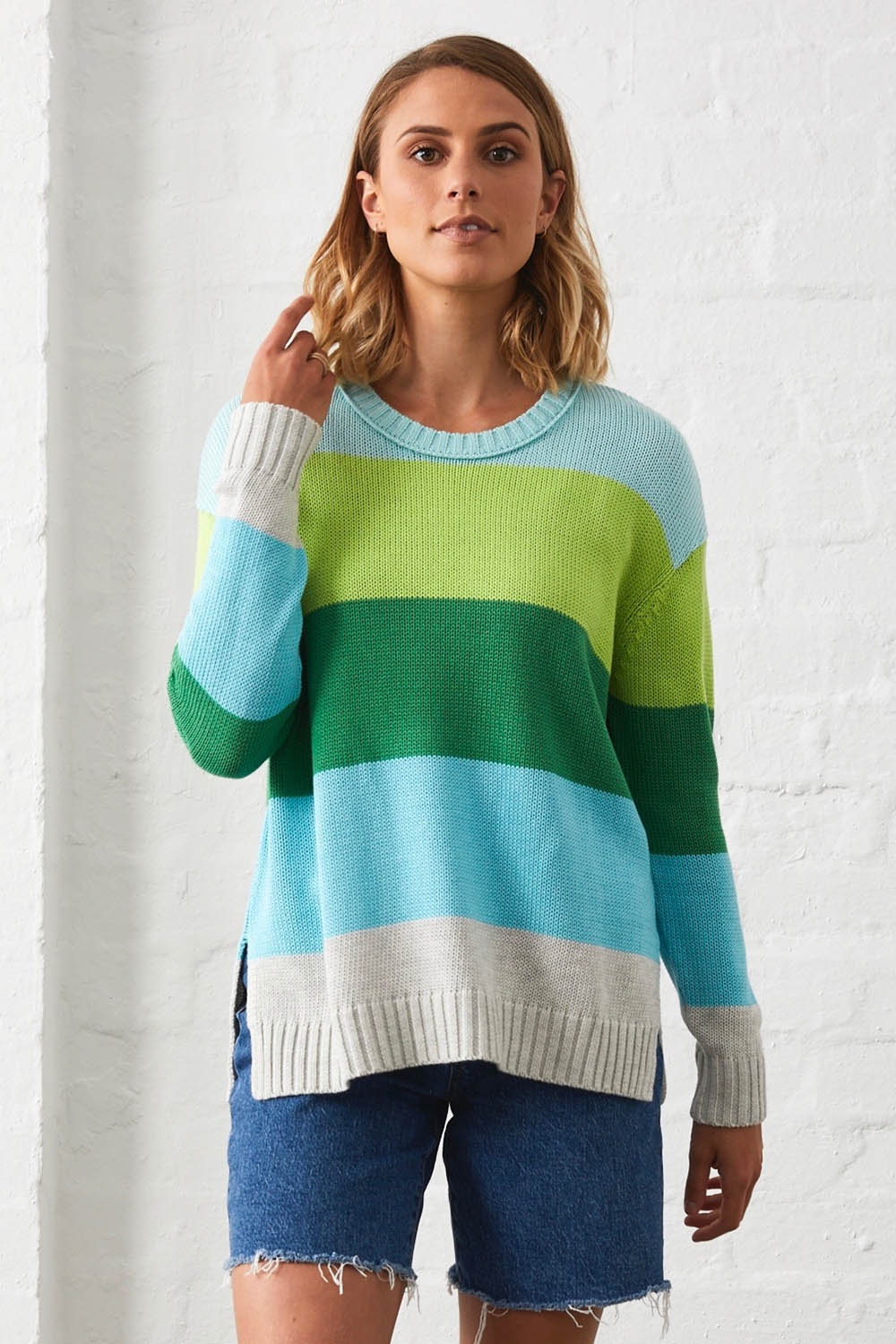 A model wearing the Mega Stripe Pullover in colour Marl (Green), from the front, showing the whole outfit
