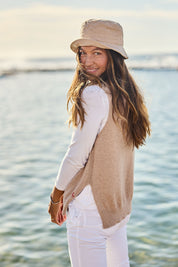 Model Alex wearing size S of the Essential Vest in colour Oat, from the front, showing the whole outfit