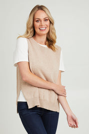 Model Grace wearing size S of the Essential Vest in colour Oat, from the front, cropped image