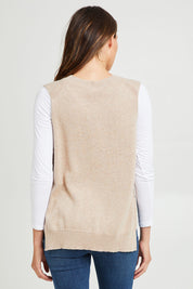 Model Madeline wearing size S of the Essential Vest in colour Oat, from the back