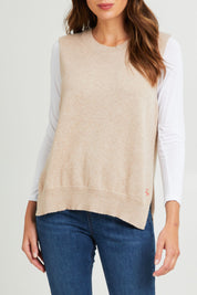 Model Madeline wearing size S of the Essential Vest in colour Oat, from the front, cropped image