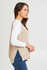 Model Madeline wearing size S of the Essential Vest in colour Oat, from the front, cropped image