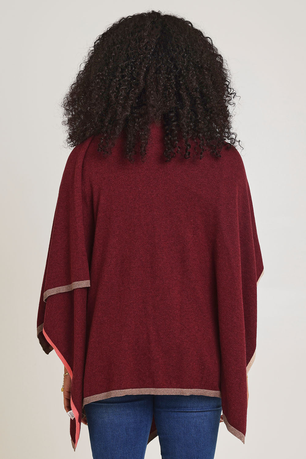 Model Ziara wearing the Cotton Cashmere Poncho in colour Shiraz, from the back
