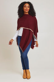 Model Ziara wearing the Cotton Cashmere Poncho in colour Shiraz, from the front, showing the whole outfit