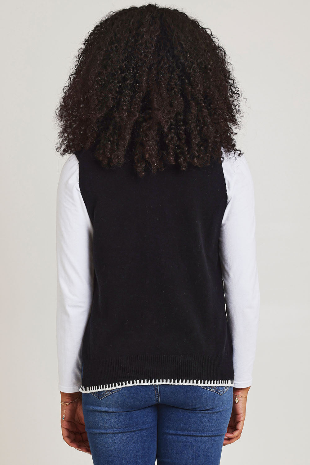 Model Ziara wearing size S of the Essential Two Tone Cotton Cashmere Vest in colour Black (Black), from the back
