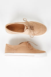 A model wearing size 37 of the Alivia Leather Sneaker in colour Lattenubuc, from the front, showing the whole outfit
