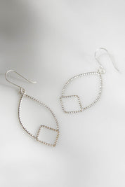 A model wearing size OneSize of the Constance Everyday Earring in colour Silver (Metallics), from the front, showing the whole outfit