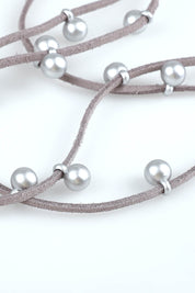 A model wearing the Emaline Multi Row Necklace in colour Silver (Metallics), from the front, showing the whole outfit