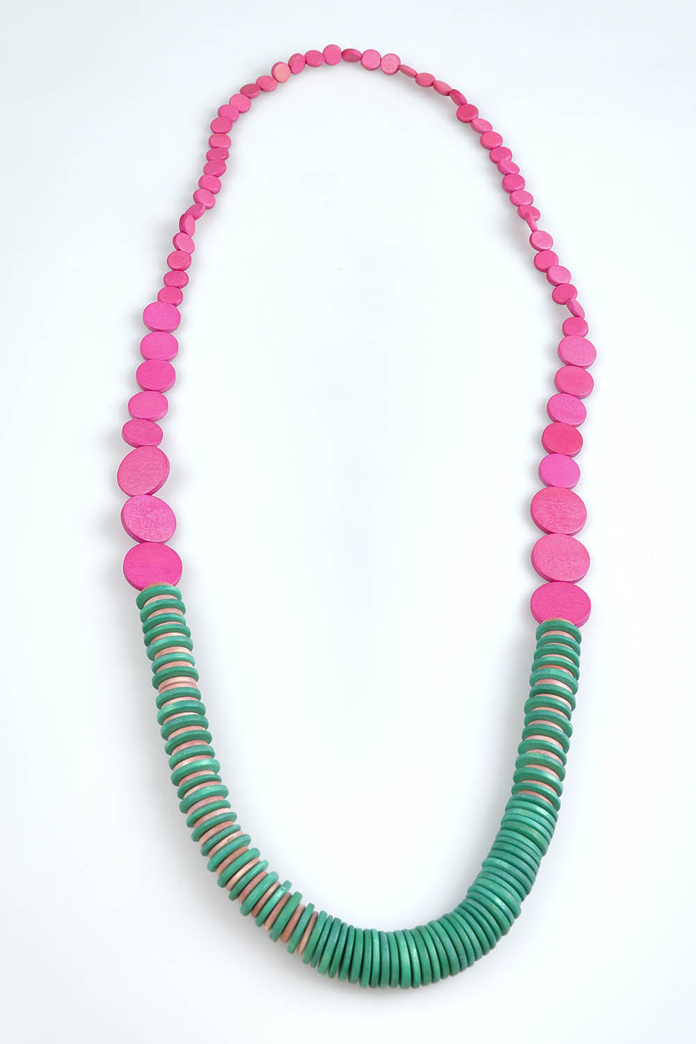 A model wearing the Laroda Wooden Necklace in colour Greenpink, from the front, showing the whole outfit